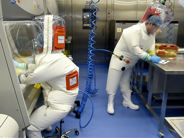 In this photo taken on Thursday, February 23, 2017, researchers work in the laboratory of the Wuhan Institute of Virology in Wuhan, central China's Hubei Province.  Claims promoted by the Trump administration that the global coronavirus pandemic originated at the Wuhan Institute of Virology in China.  A city in central China is A "pure manufacturing," The director of the institute said Sunday, May 24, 2020. (Chinatopics via AP) CHINA OUT
