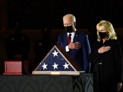 TOPSHOT - US President Joe Biden and First Lady Jill Biden pay their respects to late US C