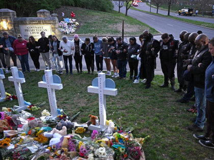 TOPSHOT - Members of the Selected First Motorcycle Club join others in prayer at a makeshift memorial for victims of a shooting at the Covenant School campus, in Nashville, Tennessee, March 28, 2023. - A heavily armed former student killed three young children and three staff in what appeared to …