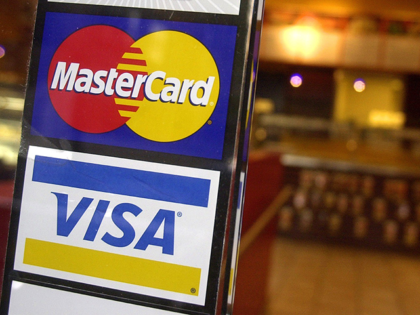 This April 22, 2005, file photo, shows logos for MasterCard and Visa credit cards at the entrance of a New York coffee shop. Mastercard and Visa are suspending their operations in Russia, the companies said Saturday, March 5, 2022, in the latest blow to the country's financial system after its …
