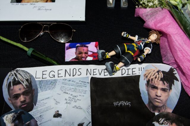 Fans leave items at a makeshift memorial outside XXXTentacion Funeral & Fan Memorial in Fl