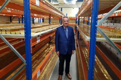 Lebanon's central bank governor Riad Salameh stands next to stacks of gold bars in the ban