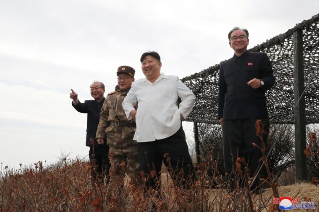 North Korean leader Kim Jong Un (2nd R) oversees the launch of a strategic cruise missile