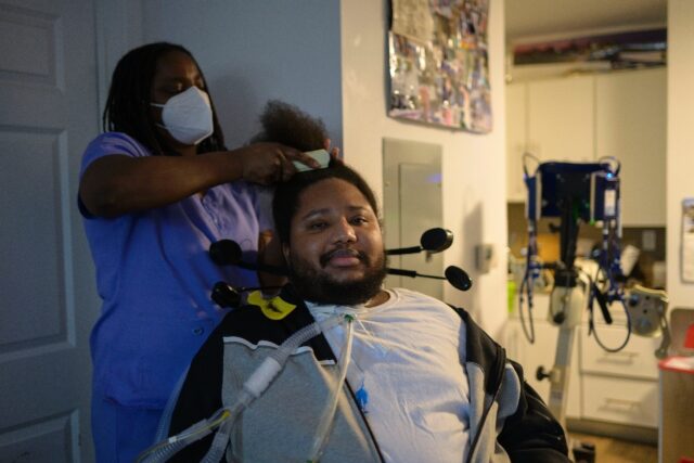 A nurse brushes the hair of gun violence survivor Ralph Norman, who was shot at 17 years o