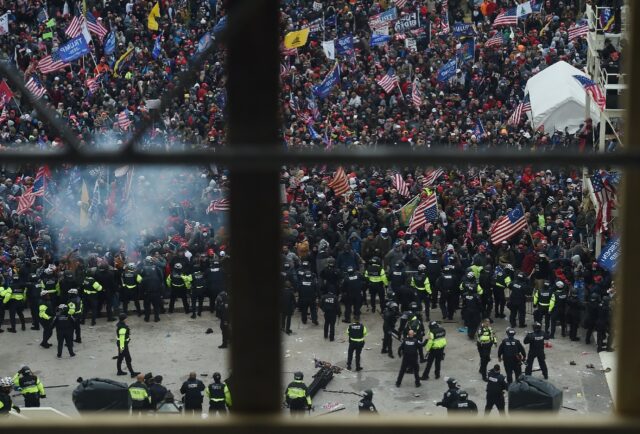 Police hold back supporters of US president Donald Trump as they gather outside the US Cap