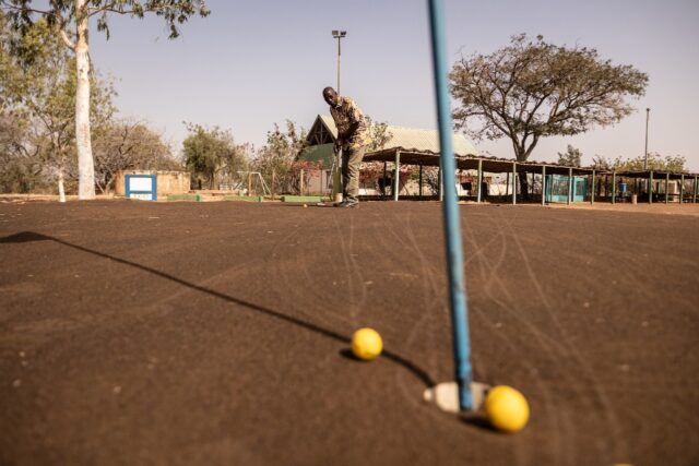 Salif Samake, president of Ouagadougou Golf Club, plays on the 'brown', a mixture of sand