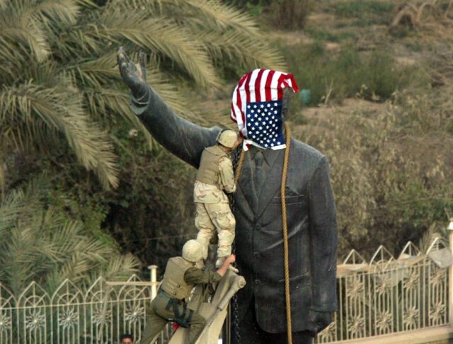 US Marines cover the statue of Iraqi President Saddam Hussein in Baghdad on April 9, 2003