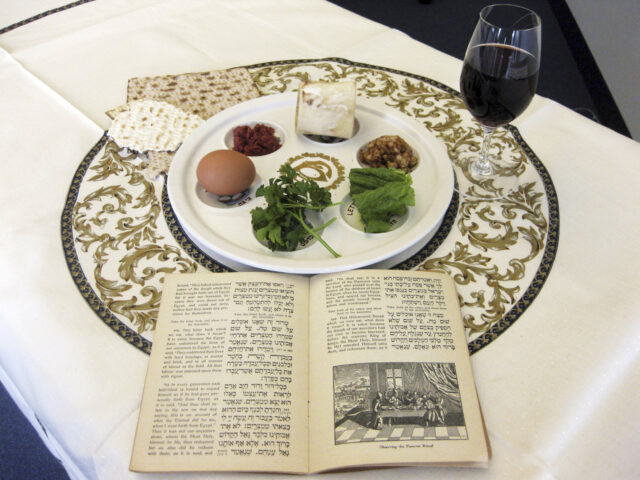 FILE - A 1936 Maxwell House Haggadah sits on a desk alongside a Seder plate on March 15, 2