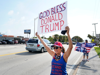 Janet Castro, a supporter of former President Donald Trump holds a sign during a rally, Monday, April 3, 2023, in West Palm Beach, Fla. (AP Photo/Wilfredo Lee)