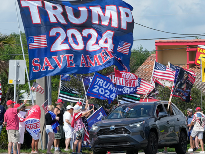 Supporters of former President Donald Trump chant and wave flags at a rally, Monday, April 3, 2023, in West Palm Beach, Fla. (AP Photo/Wilfredo Lee)
