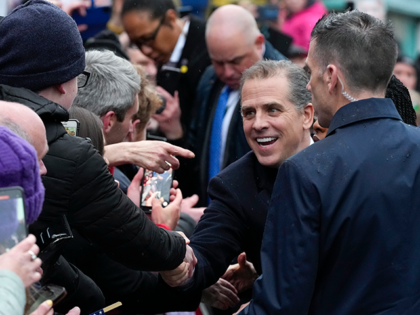 Hunter Biden, son of President Joe Biden, shakes hands with a person in the crowd as he jo