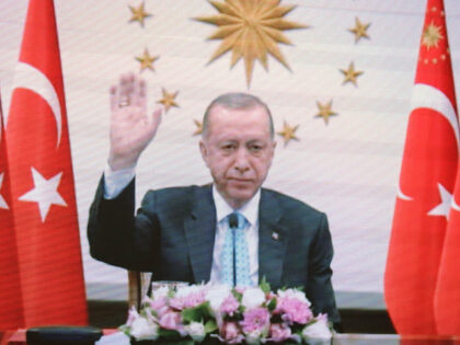 Turkish President Recep Tayyip Erdogan is seen on a TV screen as he attends a videoconference ceremony with Russian President Vladimir Putin to mark the nuclear fuel loading at the Turkey's Akkuyu Nuclear Power Plant (NPP), which is under construction in the Turkey's town of Buyukeceli, in Moscow, Russia, Thursday, …