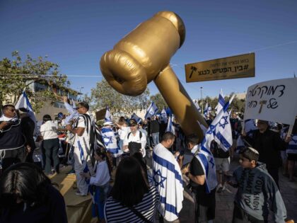 JERUSALEM - APRIL 27: Far right party supporters, hold Israeli flags, gather to demonstration of support for Israeli Prime Minister Benjamin Netanyahu near the Knesset, Israel's parliament, in Jerusalem on April 27, 2023. (Photo by Mostafa Alkharouf/Anadolu Agency via Getty Images)