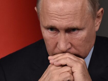 TOPSHOT - Russian President Vladimir Putin attends a conference as part of a summit called
