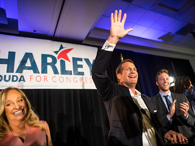 Harley Rouda waves during their election day party at the Newport Beach Marriott Hotel and