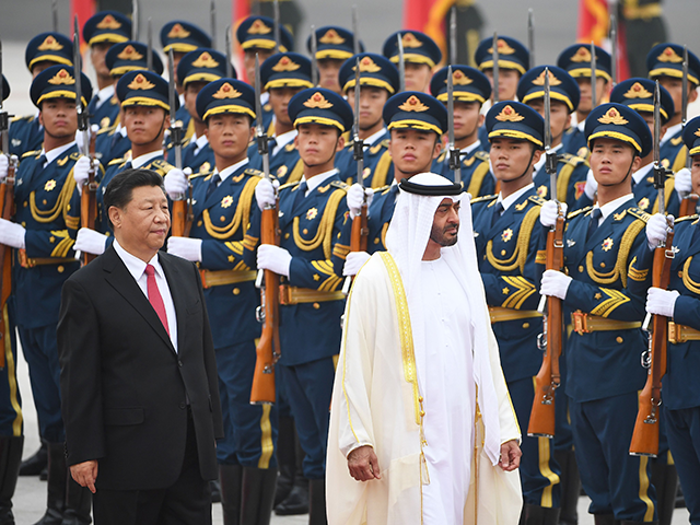 Abu Dhabi Crown Prince Mohammed bin Zayed Al Nahyan (C) reviews a military honour guard with Chinese President Xi Jinping during a welcome ceremony outside the Great Hall of the People in Beijing on July 22, 2019. (Photo by GREG BAKER / AFP) (Photo credit should read GREG BAKER/AFP via …