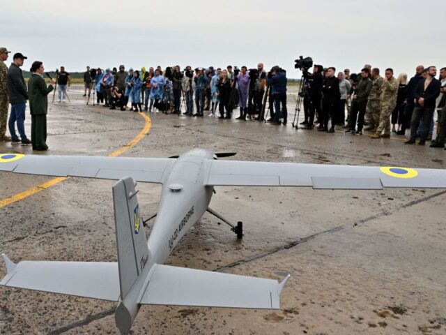 Journalists attend the presentation of a UJ-22 Airborne (UkrJet) reconnaissance drone, bou