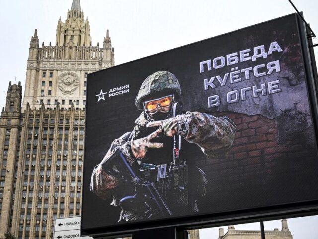 Russian Foreign Ministry building is seen behind a social advertisement billboard showing