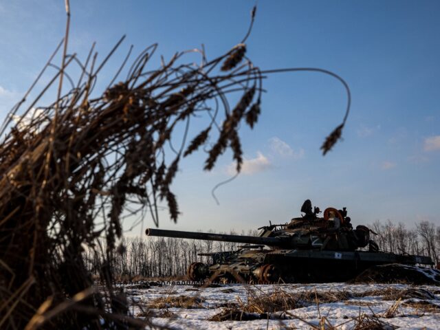 A destroyed Russian tank sits in a snow covered wheat field in Kharkiv region on February