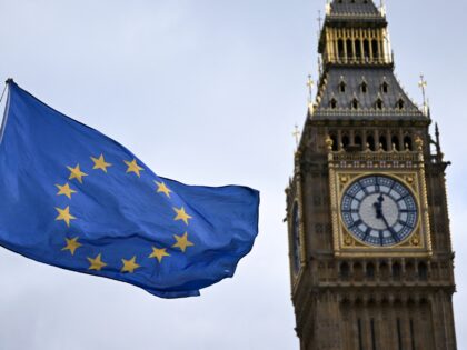 An EU flag, flown by anti-Conservative and anti-Brexit activists, flaps in wind, in front of the Elizabeth Tower, commonly known by the name of the bell inside the tower's clock, "Big Ben", and the Palace of Westminster, Houses of Parliament, in central London on March 1, 2023. (Photo by Justin …