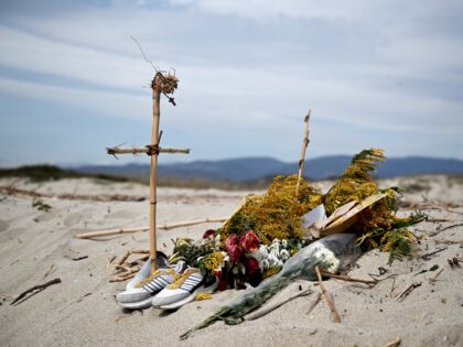 This photograph taken on March 9, 2023, shows flowers and crosses set as a memorial on a beach near Cutro, where at least 72 migrants died on February 26, after their boat sank off Italy's southern Calabria region. - Italian Prime Minister will hold a cabinet meeting on March 9 …