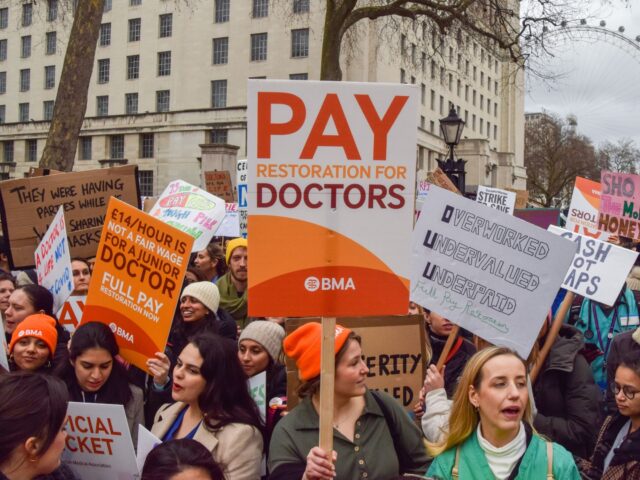 LONDON, UNITED KINGDOM - 2023/03/13: A protester holds a placard in support of pay restora