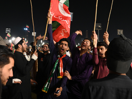 Supporters of Pakistan's former prime minister Imran Khan chant slogans at a rally in Lahore late on March 25, 2023. (Photo by Arif ALI / AFP) (Photo by ARIF ALI/AFP via Getty Images)