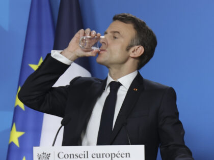 Emmanuel Macron President of the Republic of France drinks a glass of water while he talks