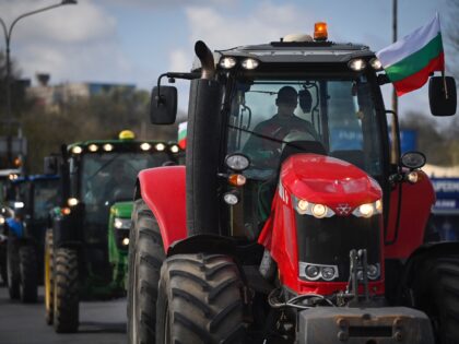 Farmers drive their tractors during an action to block trucks crossing the Danube bridge, marking the border between Bulgaria and Romania in a protest against the duty-free import of grain coming from Ukraine into the EU, in Rousse on March 29, 2023. (Photo by Nikolay DOYCHINOV / AFP) (Photo by …