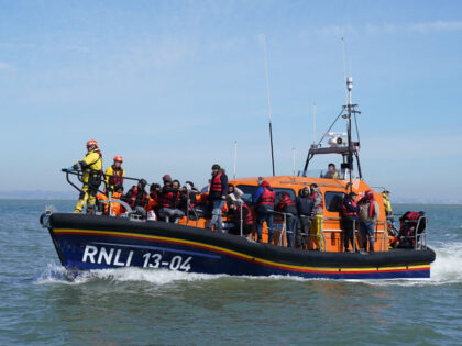 A group of people thought to be migrants are brought in to Dungeness, Kent, by the RNLI, f