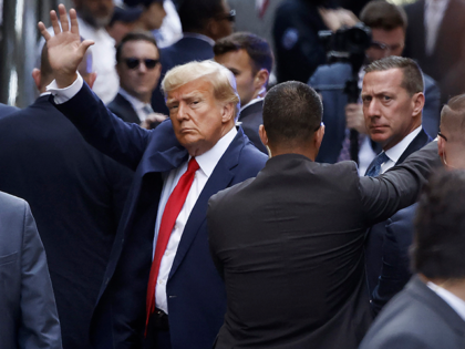 Former U.S. President Donald Trump waves as he arrives at the Manhattan Criminal Court for his arraignment hearing on April 04, 2023 in New York, New York. Trump will be arraigned during his first court appearance today following an indictment by a grand jury that heard evidence about money paid …