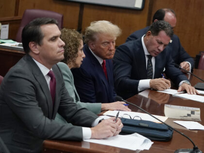 Former US President Donald Trump, center, with his defense team during his arraignment at court in New York, US, on Tuesday, April 4, 2023. Trump entered a not-guilty plea to 34 counts of falsifying business records in the first degree in a proceeding that took a little less than an …