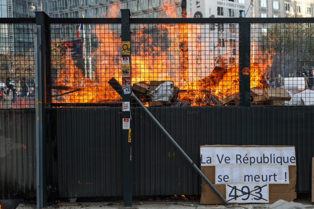 PARIS, FRANCE - APRIL06: Protesters burn materials during a demonstration after the French government pushed a pensions reform through parliament without a vote, using the article 49.3 of the constitution, in Paris, France on April 6, 2023. (Photo by Ibrahim Ezzat/Anadolu Agency via Getty Images)