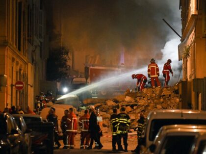 Rescue personnel work at the scene where a building collapsed in the southern French port city of Marseille early on April 9, 2023. - A building in the southern French port city of Marseille collapsed, police told AFP early on April 9, though it was unclear whether there were any …