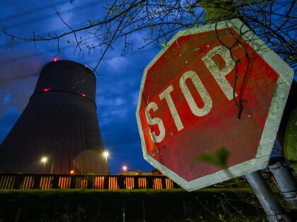 TOPSHOT - A photo taken on April 10, 2023 shows a Stop traffic sign near a cooling tower o