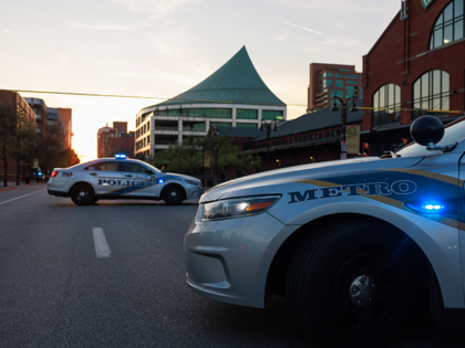 Police cars and cordon tape block Main Street near the Old National Bank after a mass shooting in Louisville, Kentucky. A gunman opened fire inside the bank, killing four people and wounding nine. (Photo by Jeremy Hogan/SOPA Images/LightRocket via Getty Images)