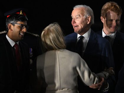 US President Joe Biden (2R) reacts as he is greeted by Britain's Prime Minster Rishi Sunak (L) after disembarking from Air Force One upon arrival at Belfast International Airport on April 11, 2023, starting a four day trip to Northern Ireland and Ireland to launch 25th anniversary commemorations of the …