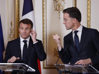 The Netherland's Prime Minister Mark Rutte (R) points towards France's President Emmanuel Macron (L) during a joint press conference following a meeting in Amsterdam on April 12, 2023. - Emmanuel Macron is on a two-day visit to the Netherlands, the first state visit by a French President for 23 years, …
