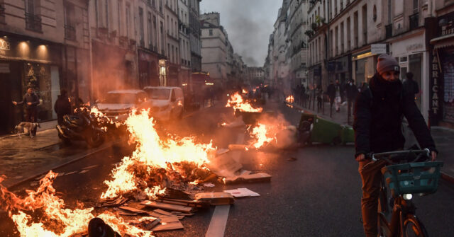 NextImg:France Burns: Macron Signs Pension Reform into Law as Paris Riots