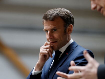 French President Emmanuel Macron (L) listens to Mathis CEO Frank Mathis (R) during a visit to Mathis, a company specialised in large wooden buildings, in Muttersholtz, eastern France on April 19, 2023. - Macron, whose reforms including an increase to the pension age have earned him widespread animosity in recent …