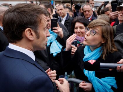 TOPSHOT - French President Emmanuel Macron (L) talks to France National Union of Autonomous Trade Unions (Union nationale des Syndicats Autonomes - Unsa) general secretary for the Grand Est region Chloe Bourguignon (R) opposed to the pension reform, in Selestat, eastern France on April 19, 2023. - Macron, whose reforms …