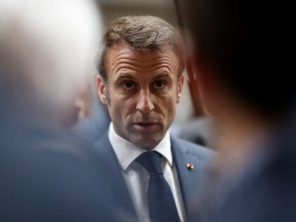French President Emmanuel Macron speaks with employees during a visit to Mathis, a company specialised in large wooden buildings, in Muttersholtz, eastern France on April 19, 2023. - Macron, whose reforms including an increase to the pension age have earned him widespread animosity in recent weeks, makes a visit on …