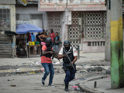Police officers patrol a neighborhood amid gang-related violence in downtown Port-au-Prince on April 25, 2023. - Between April 14 and 19, clashes between rival gangs left nearly 70 people dead, including 18 women and at least two children, according to a United Nations statement released April 24. (Photo by RICHARD …