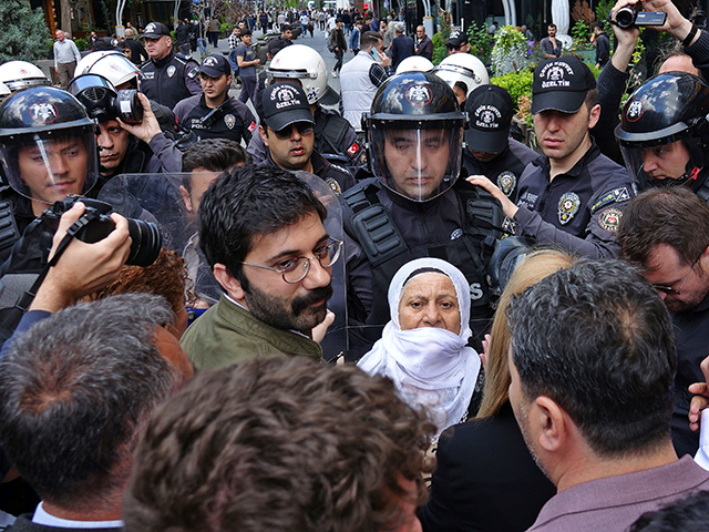 An elderly Kurdish woman is detained by police during a demonstration in Diyarbakir. More