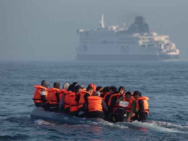 AT SEA, ENGLAND - JULY 22: An inflatable craft carrying migrant men, women and children cr