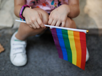 MADRID, SPAIN - JULY 09: A girl holds the rainbow flag minutes before the start of a demonstration for LGTBIQ Pride, July 9, 2022, in Madrid, Spain. The march, organized by COGAM and FELGTB, and vindictive and festive in equal parts, runs through the center of Madrid to claim the …