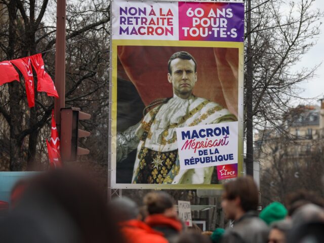PARIS, FRANCE - MARCH 07: A demonstrator carries an anti-Macron placard at a protest durin