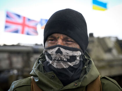 SOUTH WEST, ENGLAND - MARCH 24: A Ukrainian soldier is seen with flags of Ukraine and the United Kingdom during their final training, on March 24, 2023 in South West, England. Ukrainian artillery recruits come to the end of their training on AS90 155mm self-propelled gun. Ukrainian personnel have been …