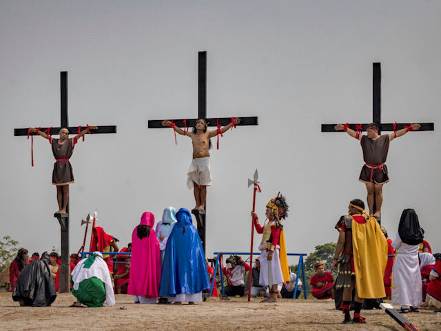 SAN FERNANDO, PHILIPPINES - APRIL 07: Penitent Ruben Enaje (center) is nailed to a cross d