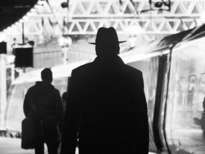 Man with hat at Victoria train station.